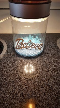 a glass jar sitting on top of a counter next to a stovetop burner