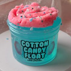 a blue container filled with pink cotton candy floss