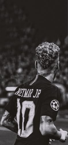 a black and white photo of a soccer player