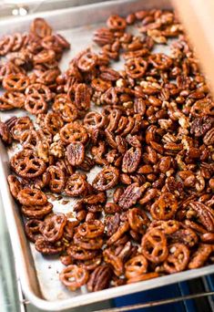 a tray full of pretzels sitting on top of a stove