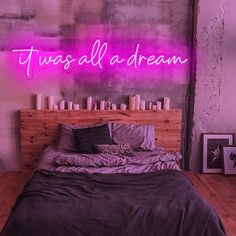 there is a neon sign above the bed that says, tues all a dream