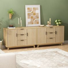 a living room scene with focus on the sideboard and rug in the foreground