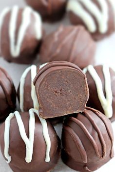 chocolates with white icing on them sitting on a table