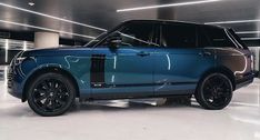 a blue range rover parked in a parking garage