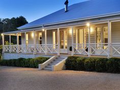 a white house with porches and steps leading up to it