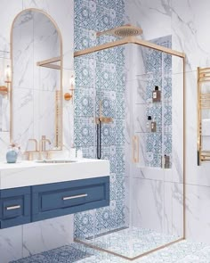 a bathroom with blue and white tiles on the walls, sink, shower stall and mirror