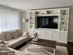 a living room filled with furniture and a flat screen tv