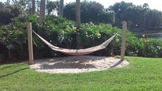 a hammock in the middle of some grass