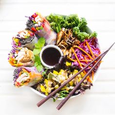 a plate filled with different types of food and chopsticks on top of it