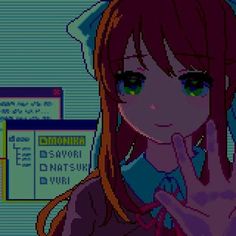 a girl with long red hair and green eyes making the v sign in front of a computer screen