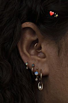 a close up of a person's ear with two piercings on top of it