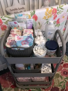 a baby crib filled with lots of diapers and supplies on top of it