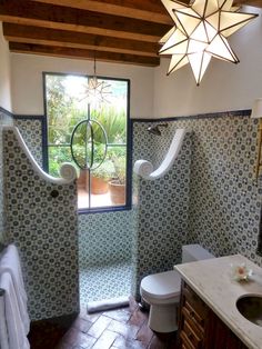 a bathroom with blue and white tiles on the walls