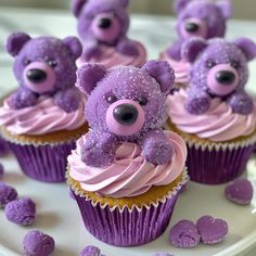 cupcakes with purple frosting and teddy bears on top