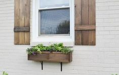 a window box with flowers in it on the side of a building