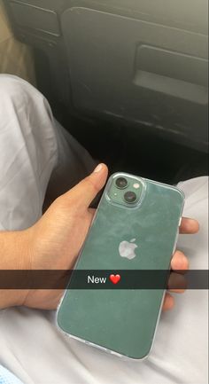 a person holding an iphone in their hand with the new heart sticker on it