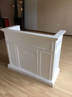 a white counter sitting on top of a hard wood floor