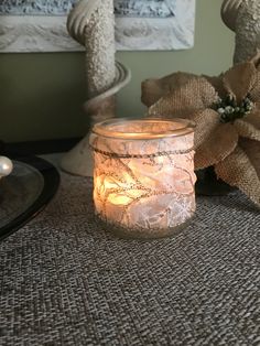 a lit candle sitting on top of a table