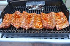 steaks are cooking on the grill outside