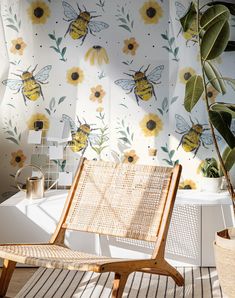 a chair sitting on top of a wooden floor next to a wall covered in flowers