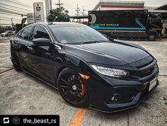 a black car parked in front of a gas station