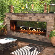 an outdoor fireplace is lit with candles on it