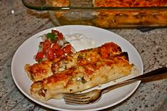 a white plate topped with food next to a casserole dish