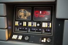 a control panel with lights and buttons on the side of it, in a star wars vehicle