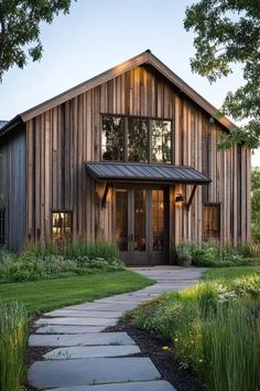 a house that is made out of wood and has a walkway leading to the front door