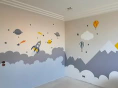 a child's room painted with space themed wall decals and balloons in the sky