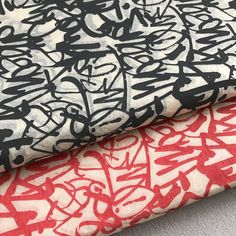 two different types of fabric with black and red designs