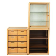 a wooden cabinet with glass doors and drawers next to it's side view on a white background