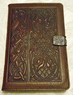 a brown leather journal with celtic designs on it