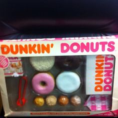 a dunkin donuts box with various types of doughnuts in the front