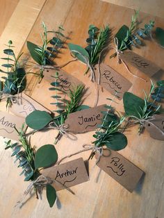 the place cards are tied with twine and green leaves