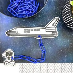 an image of a space shuttle being chained to a ball and chain on the table