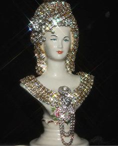 a white mannequin with lots of silver sequins on it's head