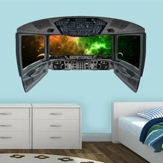 a bedroom with a bed, dressers and a wall mounted tv in the shape of a spaceship