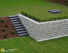 an aerial view of a building made out of rocks and grass with steps leading up to it