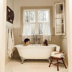 two children are sitting in the bathtub