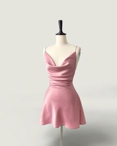 a mannequin wearing a pink dress on a white background