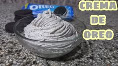 a bowl filled with ice cream next to oreo cookies and a bag of creme