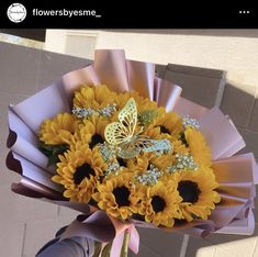 a person holding a bouquet of sunflowers and a butterfly