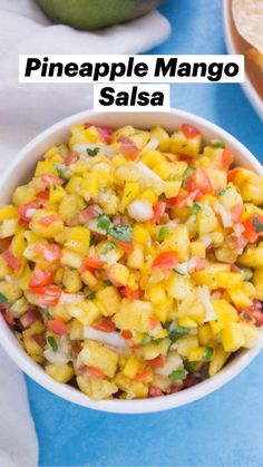 pineapple mango salsa in a white bowl with tortilla chips on the side