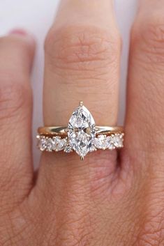 a woman's hand with a diamond ring on it