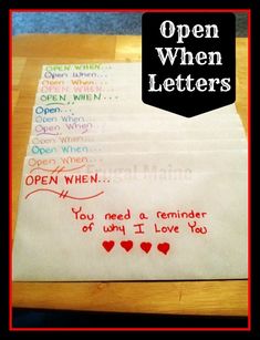 an open letter is on the table with hearts and words written in red, black, and white