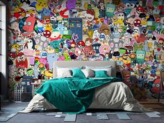 a bed sitting under a window next to a wall covered in cartoon characters