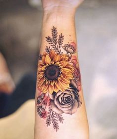 a woman's arm with a sunflower and roses tattoo on the left wrist