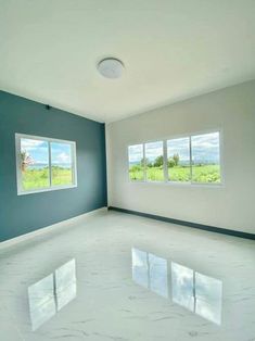 an empty room with three windows in it