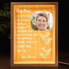 a wooden frame with an image of a woman's face and words on it